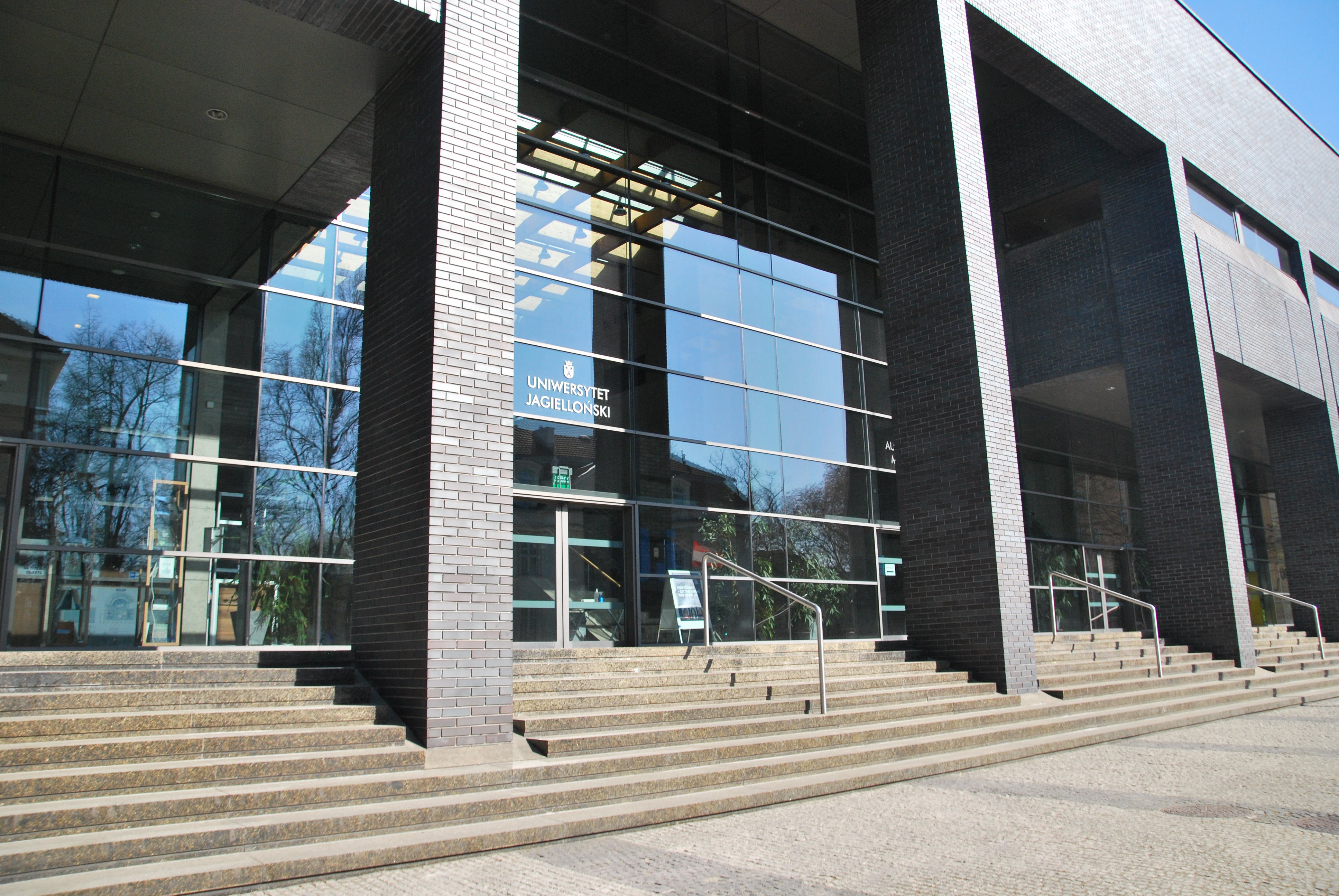 The main entrance to the Auditorium Maximum. It is located in the glass façade, between two columns. Stairs with handrails lead to the entrance.
